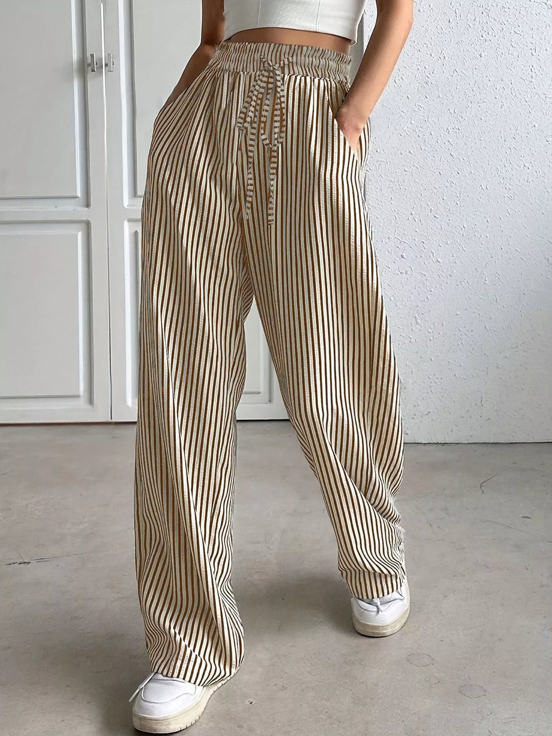 Taupe vertical pinstripe wide leg pants with drawstring waist, front view