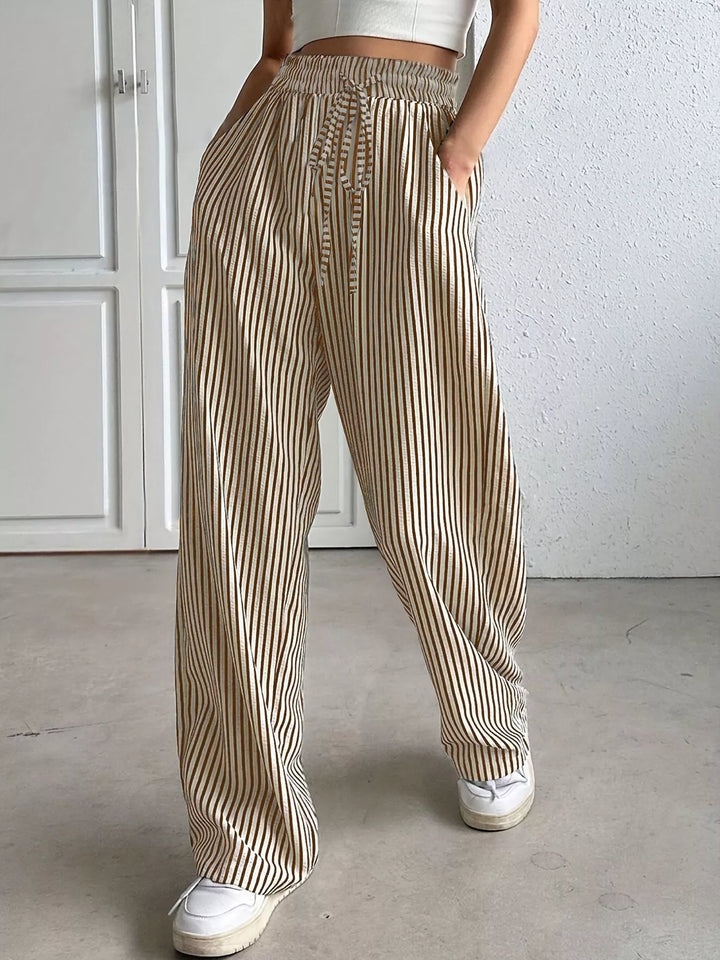 Taupe vertical pinstripe wide leg pants with drawstring waist, front view