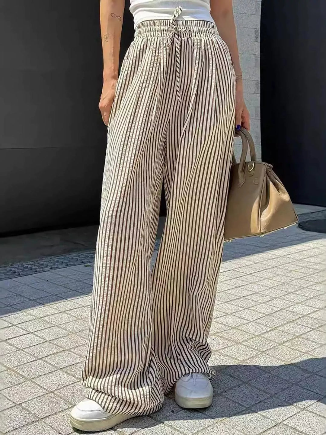 Taupe pinstripe pants full length with sneakers and drawstring