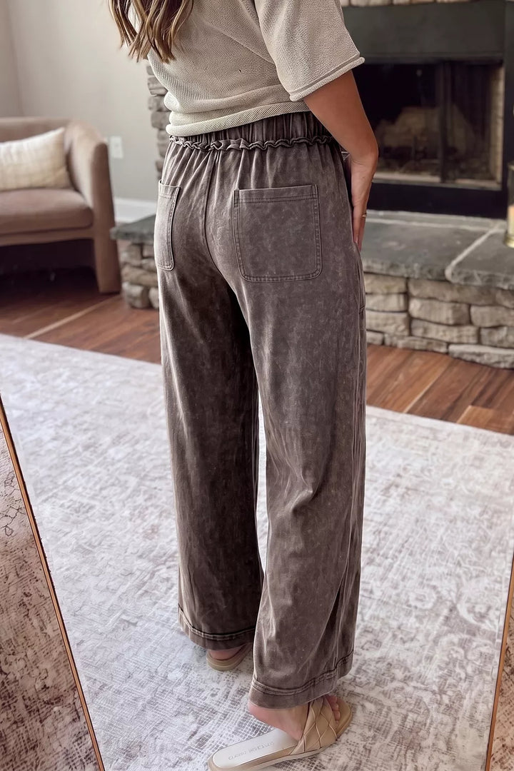 Back view of coffee brown washed wide leg pants with relaxed fit