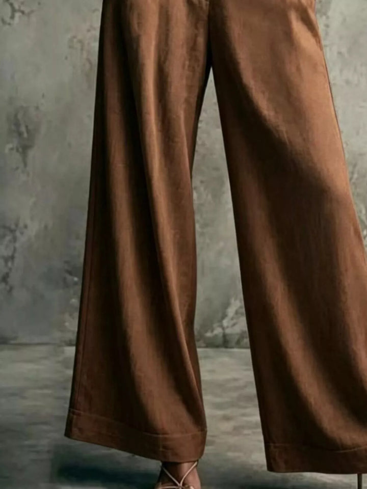 Brown wide leg trousers, close-up of the flowing leg and hem