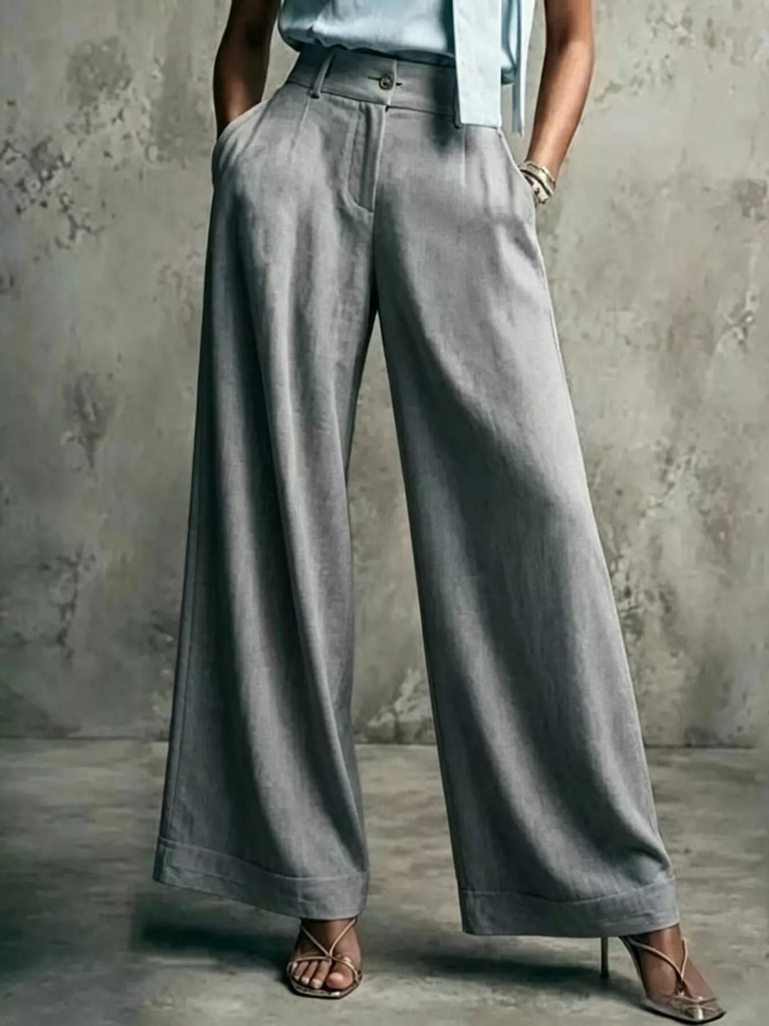 Gray wide leg trousers with a high waist, standing pose