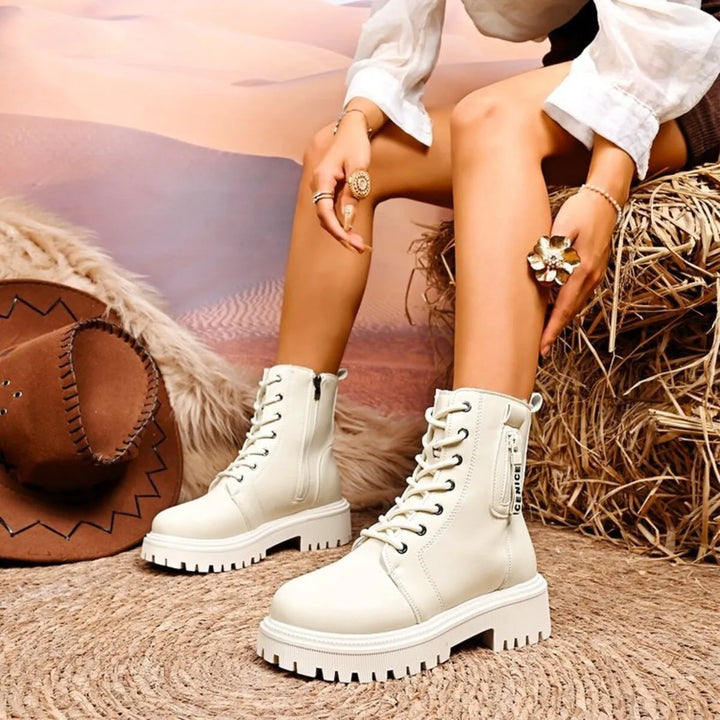 Ivory lace up platform boots worn with a white blouse and ring details