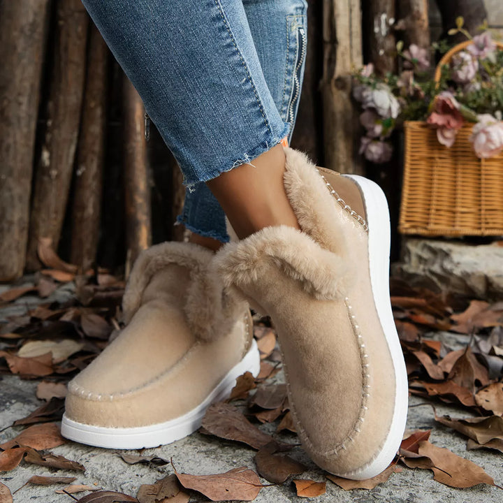 Beige plush collar ankle boots, side view with white sole and jeans
