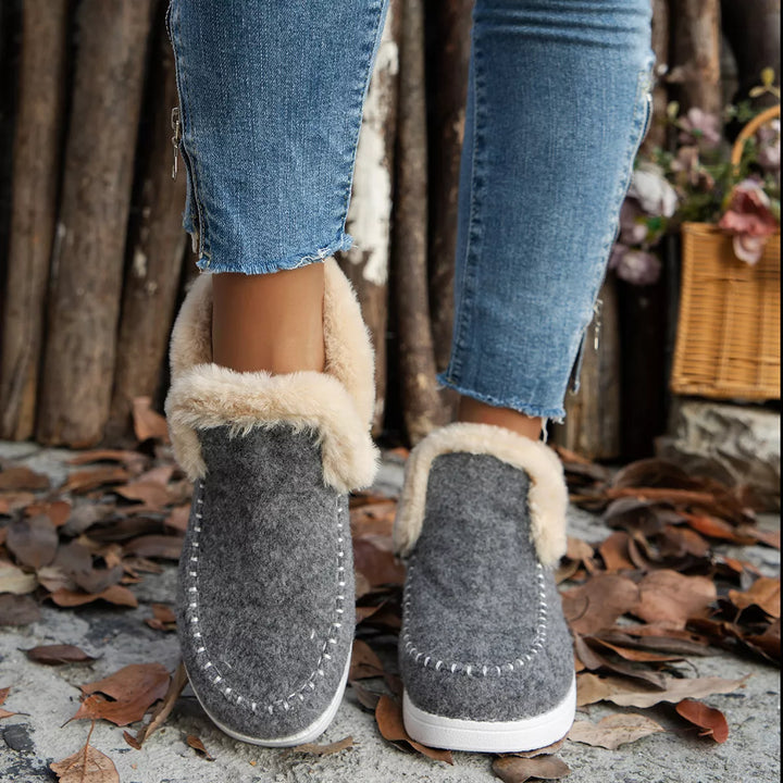 Gray slip on ankle boots with plush collar and contrast stitching, front view