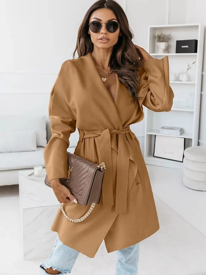 Camel waterfall coat styled with sunglasses, jeans and a chain strap bag