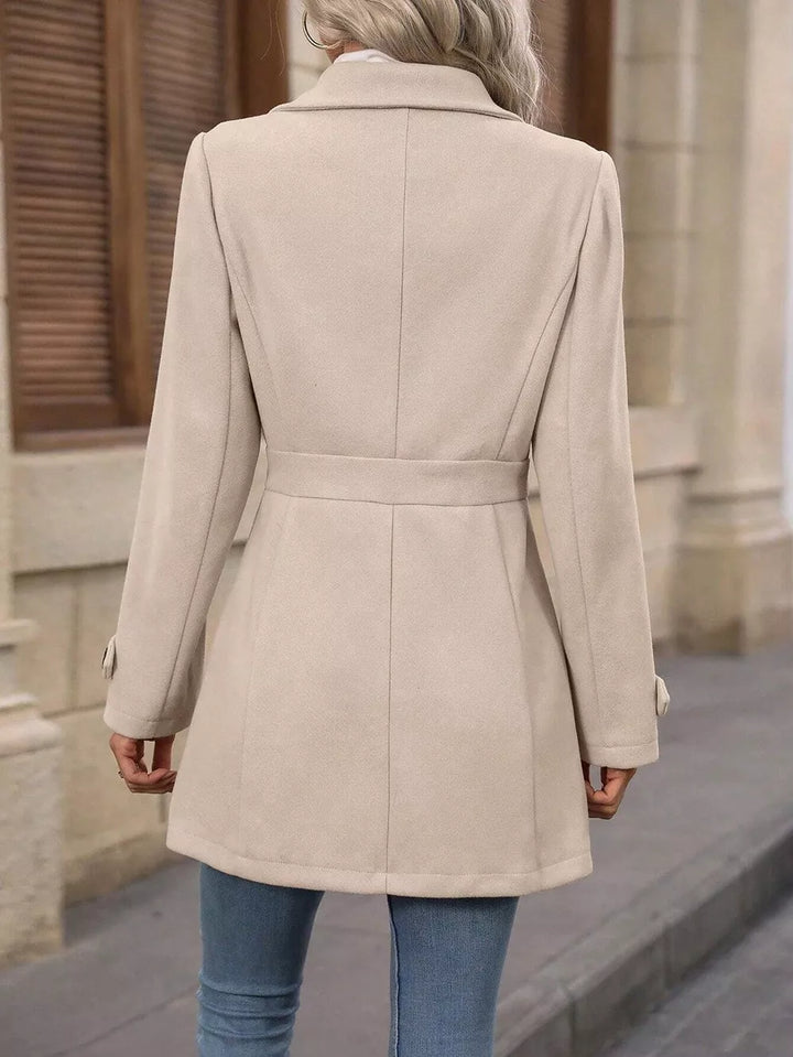 Back view of the beige winter coat showing the fitted waist and collar