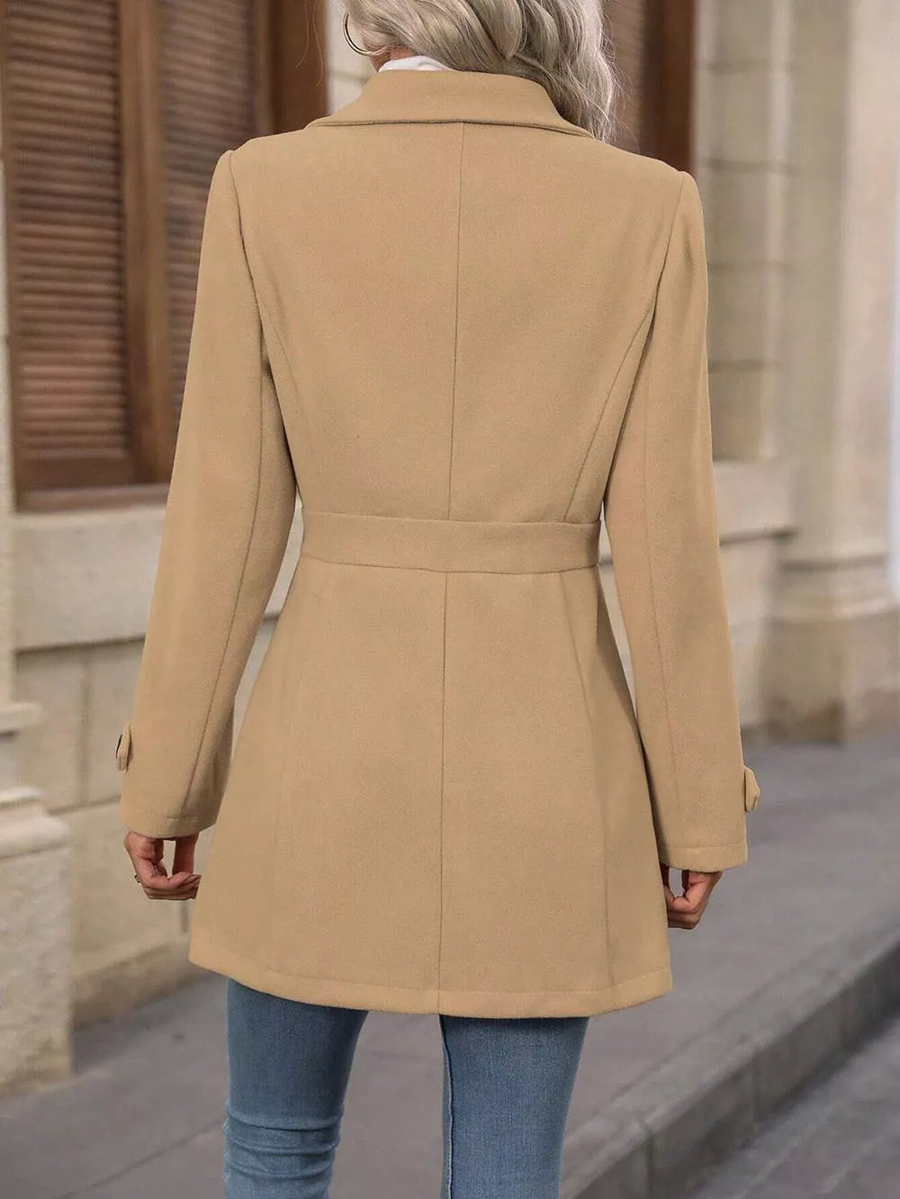 Back view of the camel winter coat with a defined waist seam