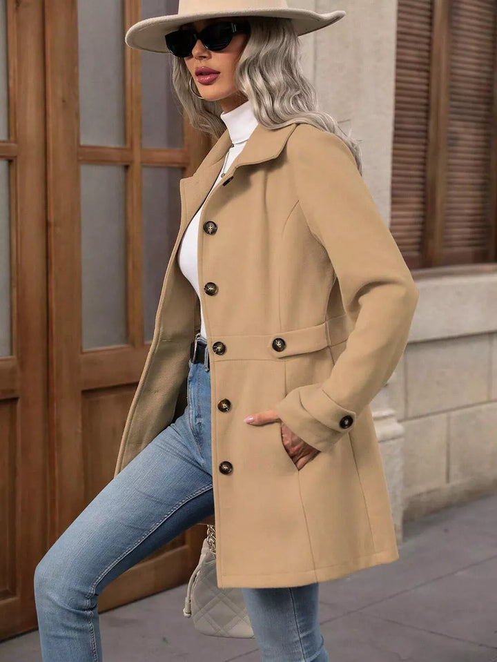 Camel winter coat side view with hand in pocket, finished with a wide brim hat