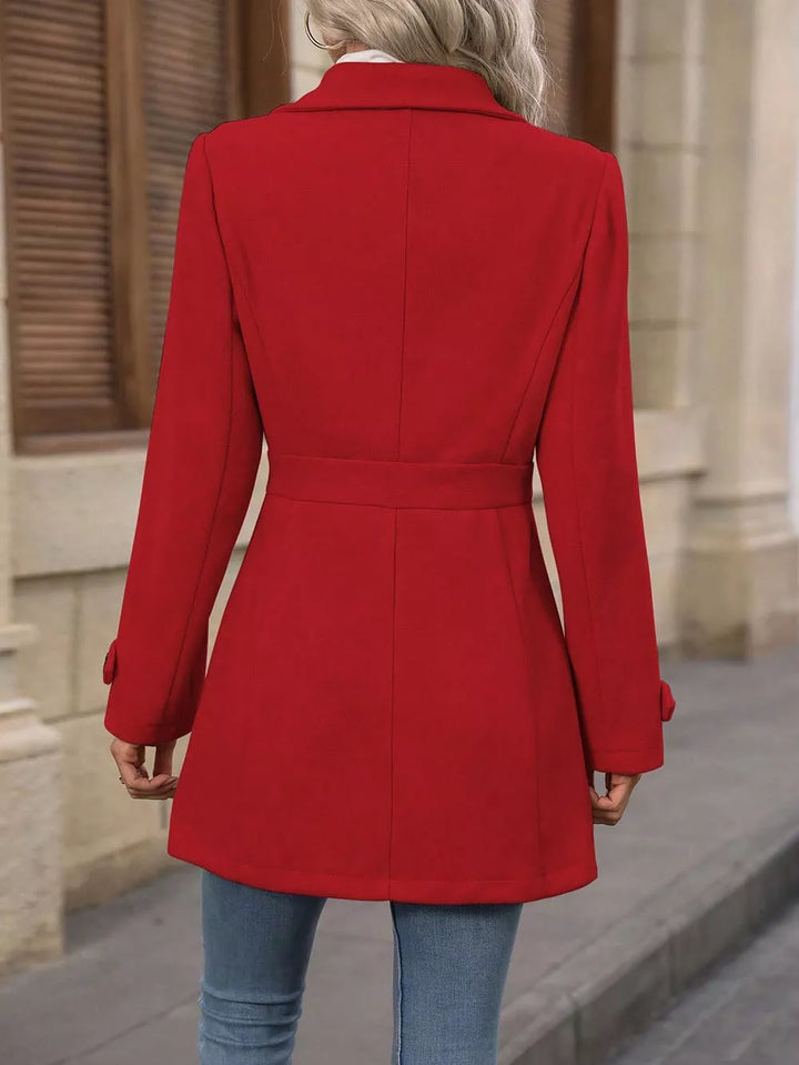 Back view of the red winter coat showing the tailored waist