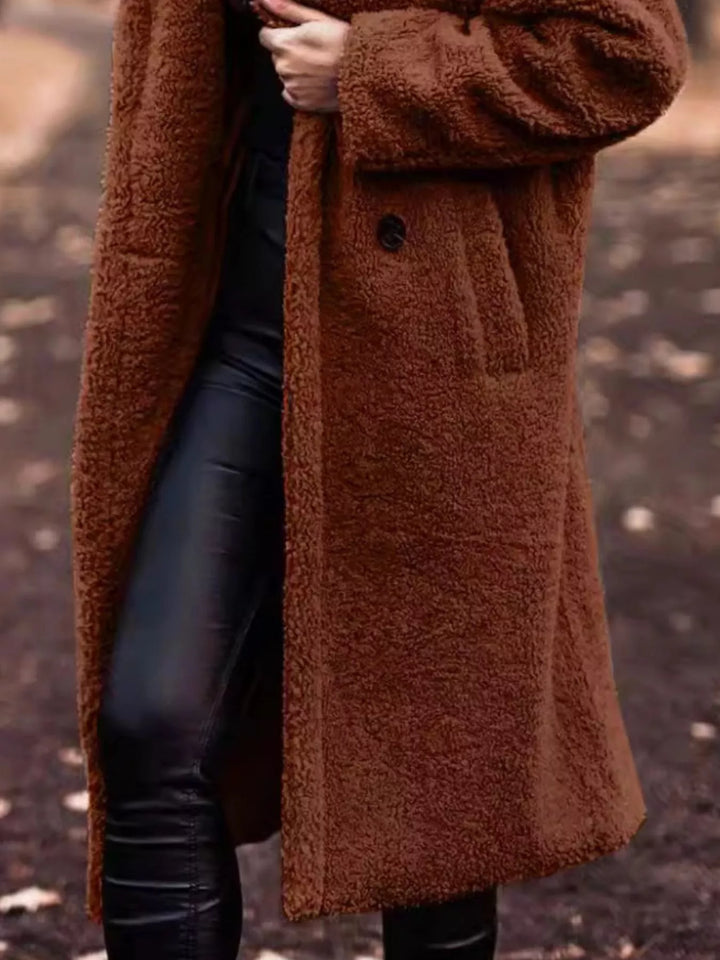 Rust longline open front coat showing the pocket and skirt length