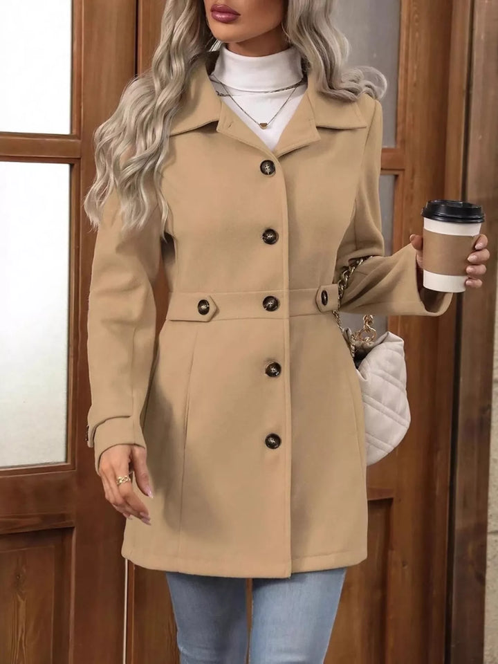 Camel belted waist coat front view with a coffee cup in hand