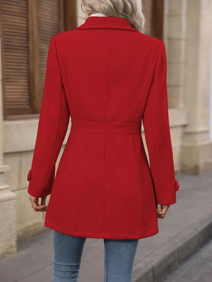 Back view of the red coat with fitted belted waist