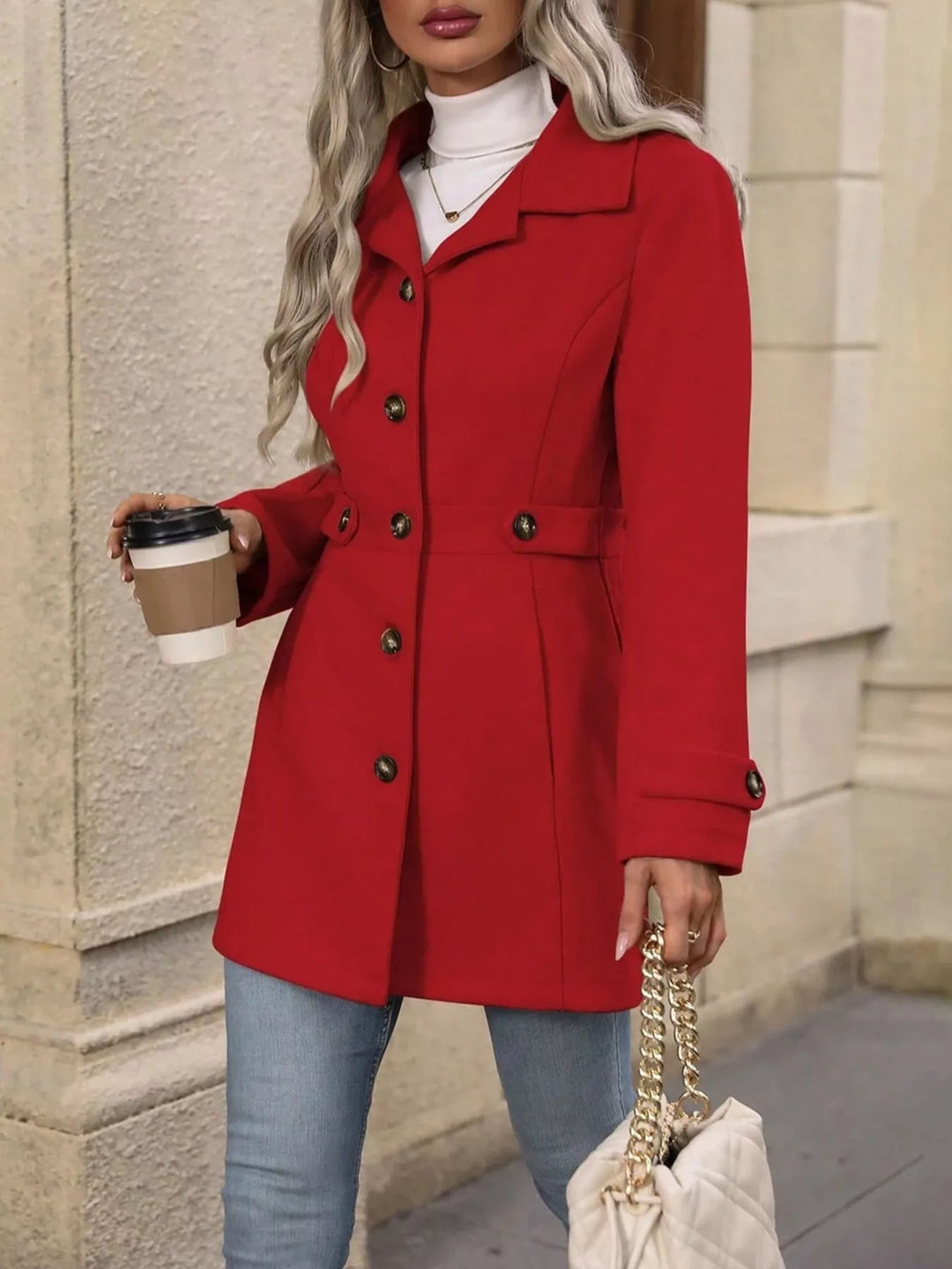 Red winter coat front view with hand holding a coffee cup and chain bag